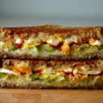 breakfast grilled cheese filled with avocado, sriracha, and egg