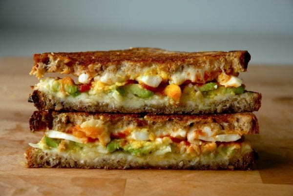 breakfast grilled cheese filled with avocado, sriracha, and egg