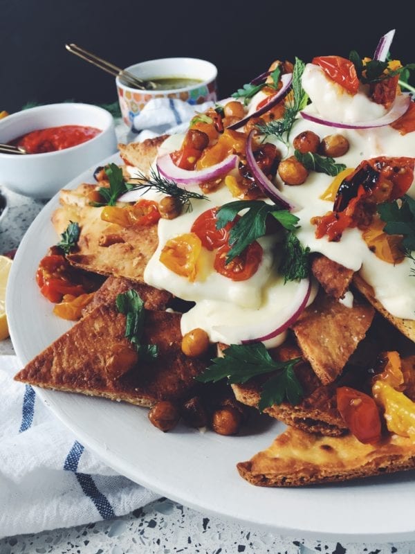 These tasty naan nachos are smothered in a creamy feta cheese sauce with roasted tomatoes, chick peas and fresh herbs!