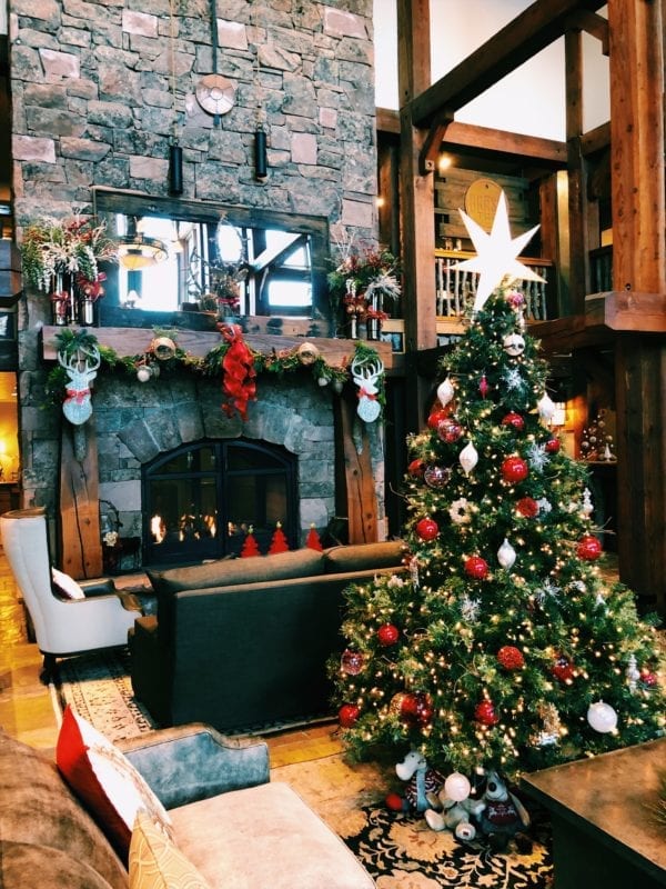 The lobby of Deer Valley Lodges with a christmas tree and fireplace