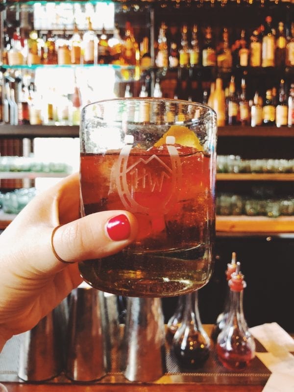 a hand holding a cocktail at High West Distillery in Park City Utah