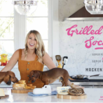 mackenzie smith of grilled cheese social with her two dachshunds in a kitchen