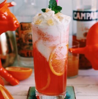 an orange cocktail with ice cream on top