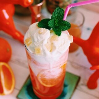 an orange cocktail with ice cream on top