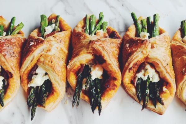 asparagus wrapped in puff pastry on a white counter top