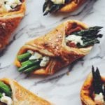 asparagus wrapped in puff pastry on a white counter top