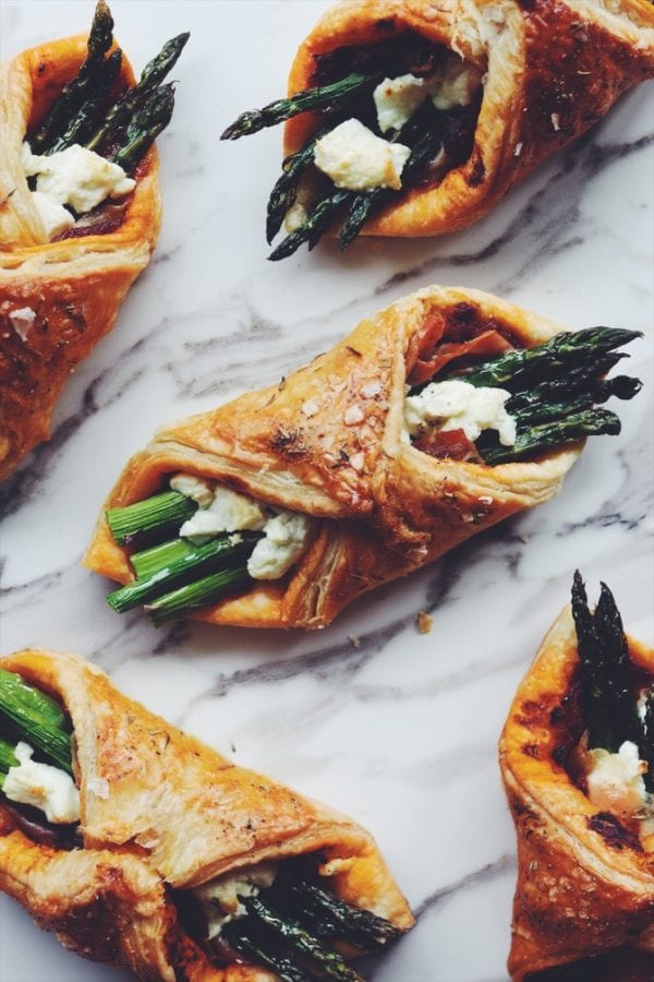 asparagus wrapped in puff pastry on a white counter top