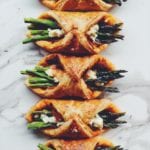 asparagus wrapped in puff pastry on a white counter top