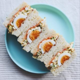 egg salad sandwiches on a blue plate