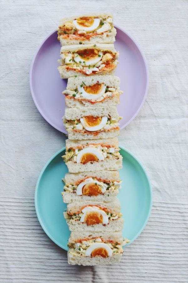 egg salad sandwiches on a blue and purple plate