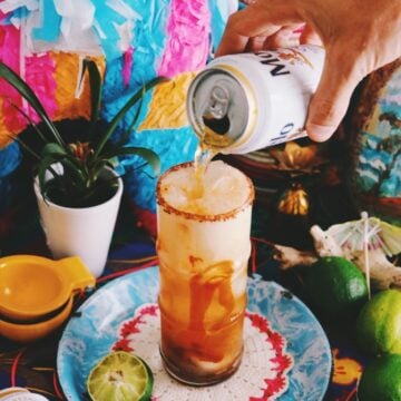 a beer being poured into a michelada