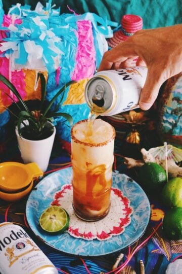 a beer being poured into a michelada