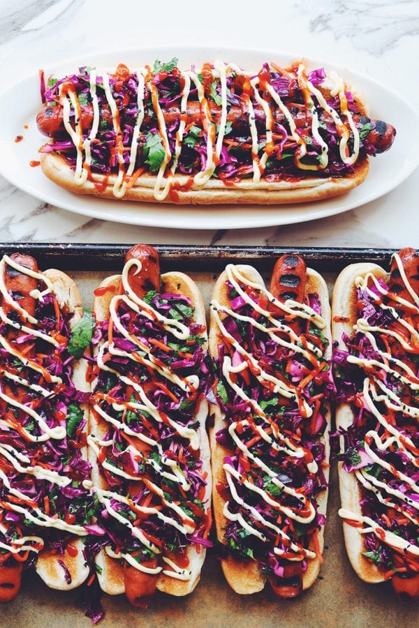 colorful asian slaw dogs on a table