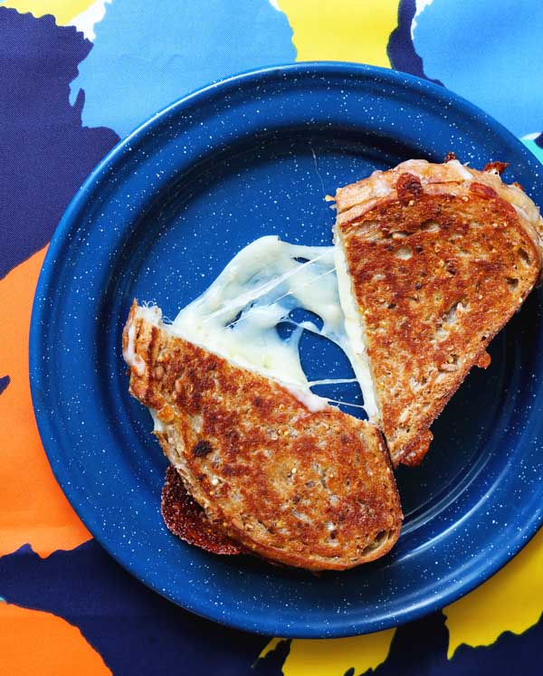 Grilled cheese sandwich being grilled in frying pan Stock Photo