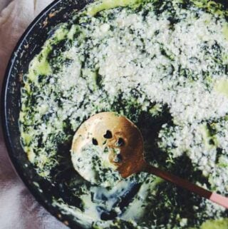 creamed spinach in a black cast iron