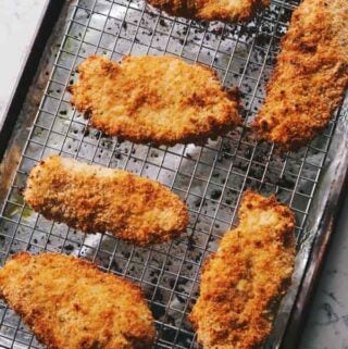 oven baked crispy chicken cutlets on a wire rack.