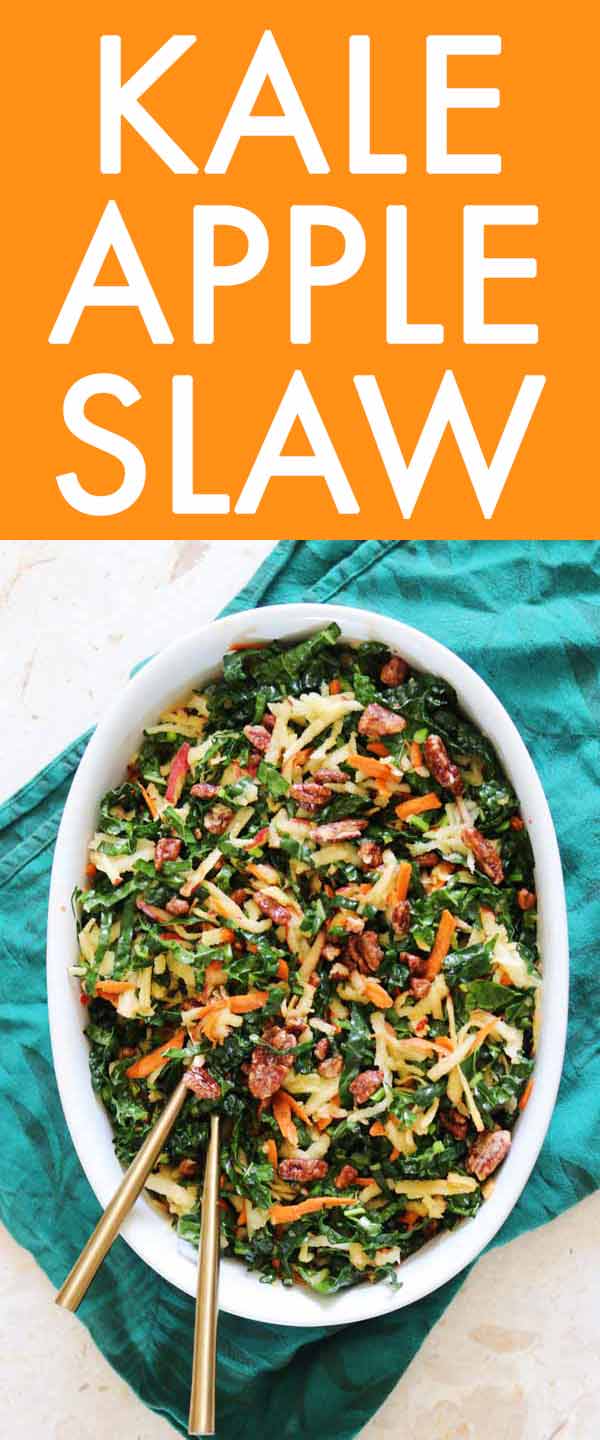 This Kale Apple Slaw is the perfect seasonal hearty green salad. Fresh lemony shredded kale is paired with apples and carrots then tossed in a sweet yet tangy maple dijon vinaigrette. The whole thing is topped which candied nuts for an added textural crunch. #fallfood #fallrecipes #kale #kalesalad #kaleslaw #heartygreens #fall