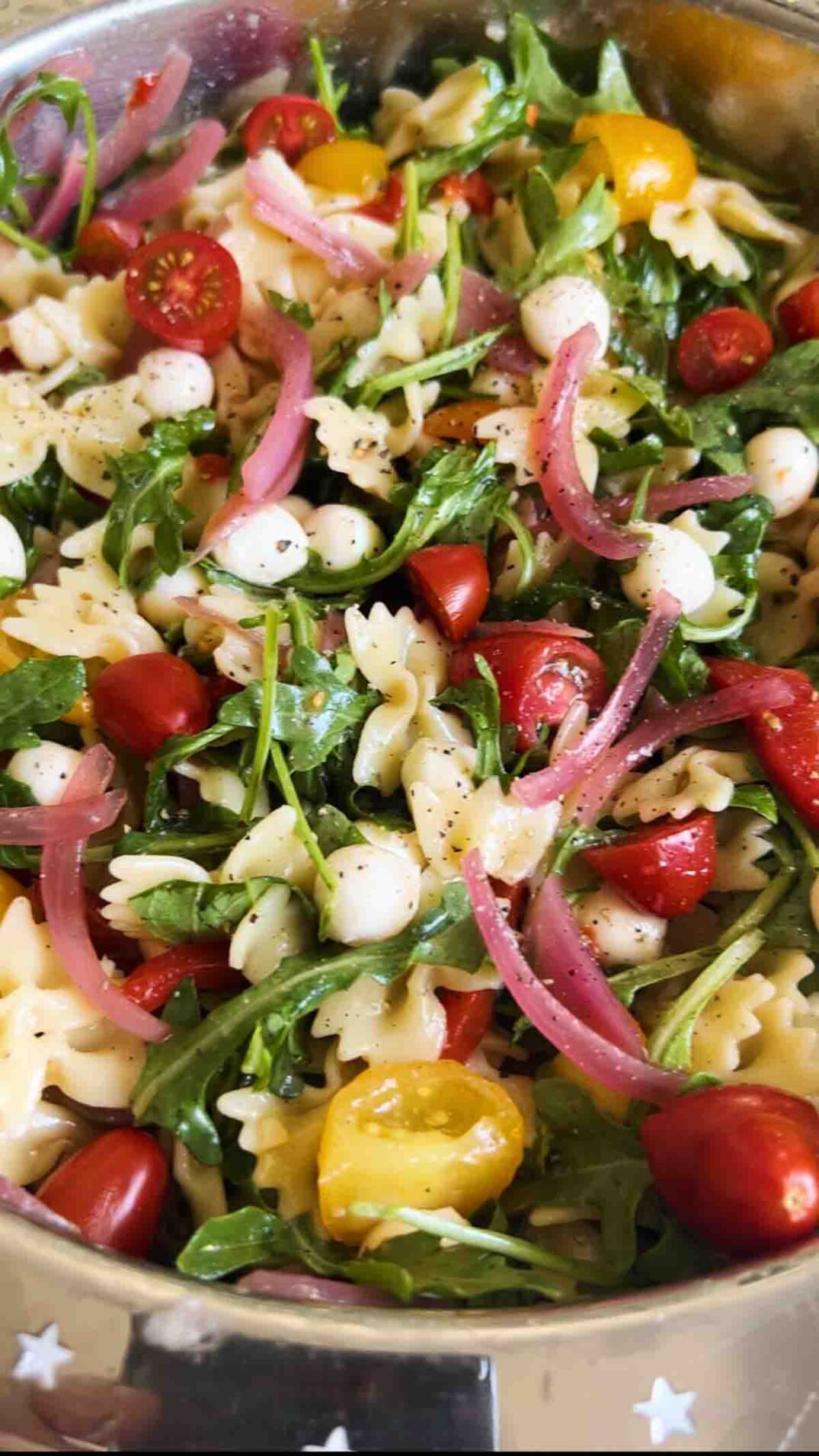 an up close view of caprese pasta salad.