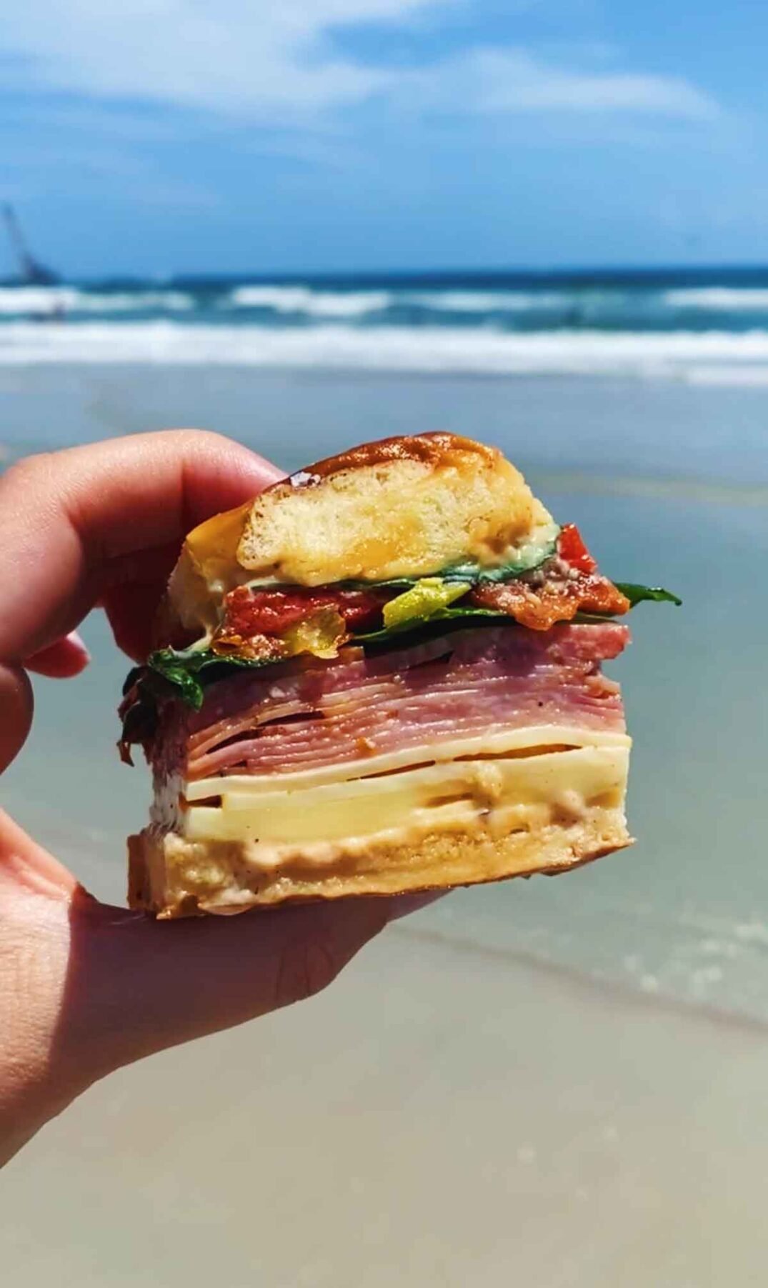 a colorful italian slider sandwich at the beach.