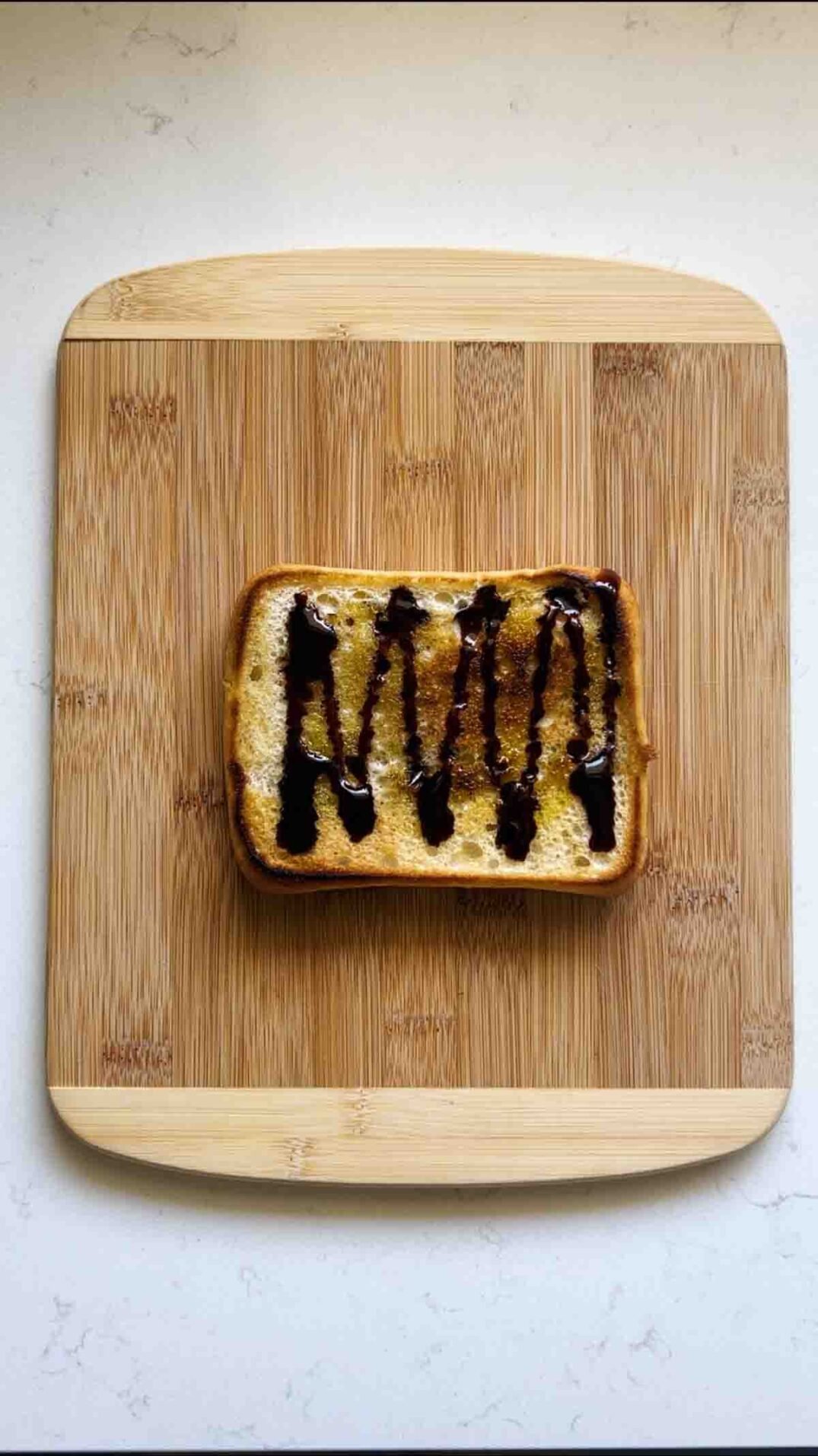 a drizzle of balsamic glaze on an olive oil toasted piece of ciabatta bread.