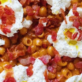 an up closer view of spicy vodka pasta with bacon and burrata.