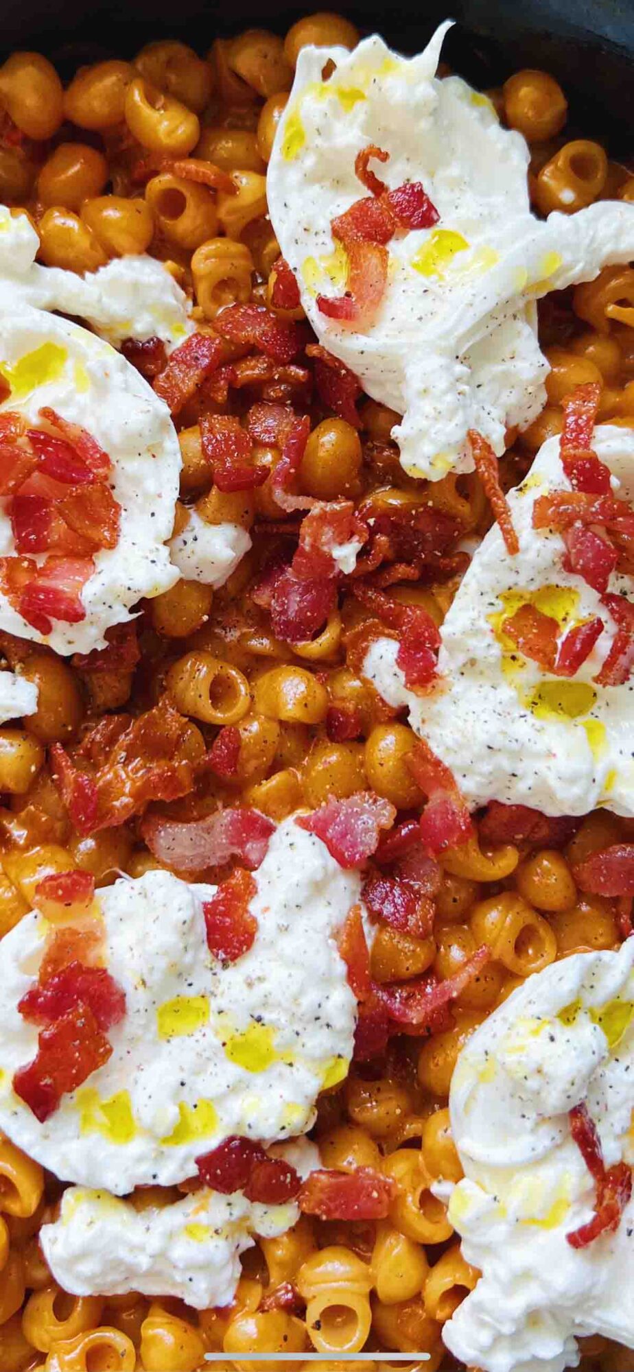 an up closer view of spicy vodka pasta with bacon and burrata.