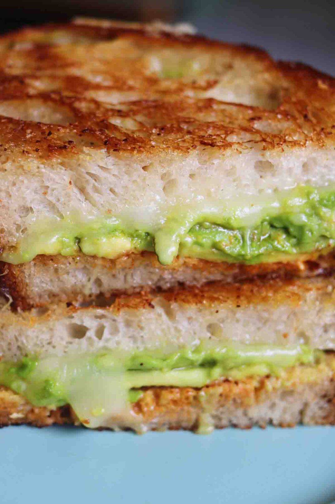 avocado and melted cheese on sourdough bread.