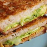 an up close overhead view of a cheesy chipotle avocado grilled cheese.