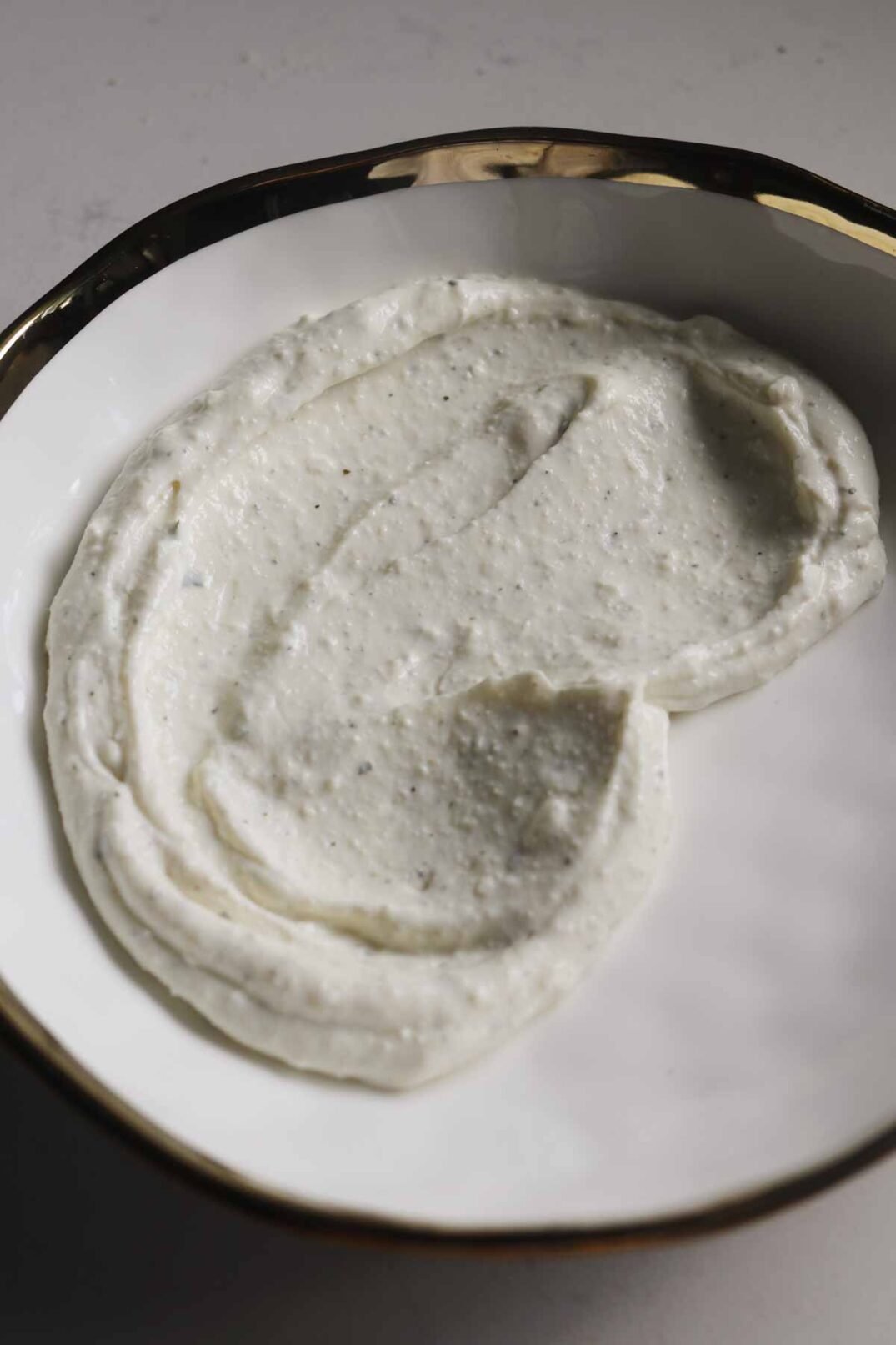 whipped cottage cheese ranch on a white plate.
