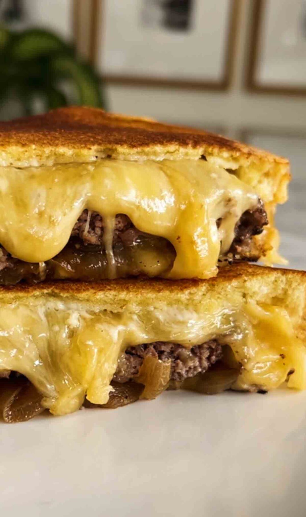 up close shot of a cut open truffle burger grilled cheese.