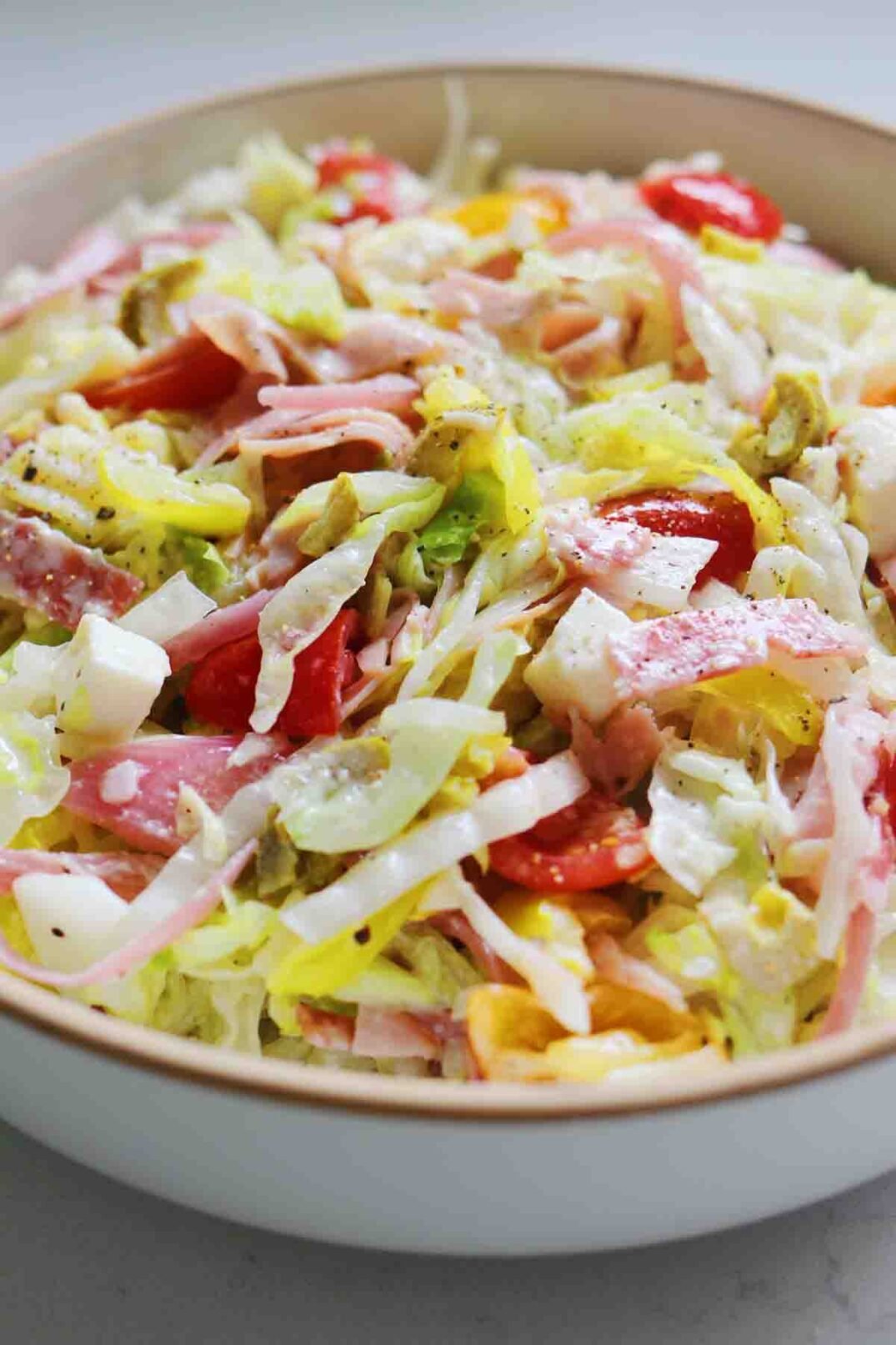 an angled view of a colorful chopped grinder salad.