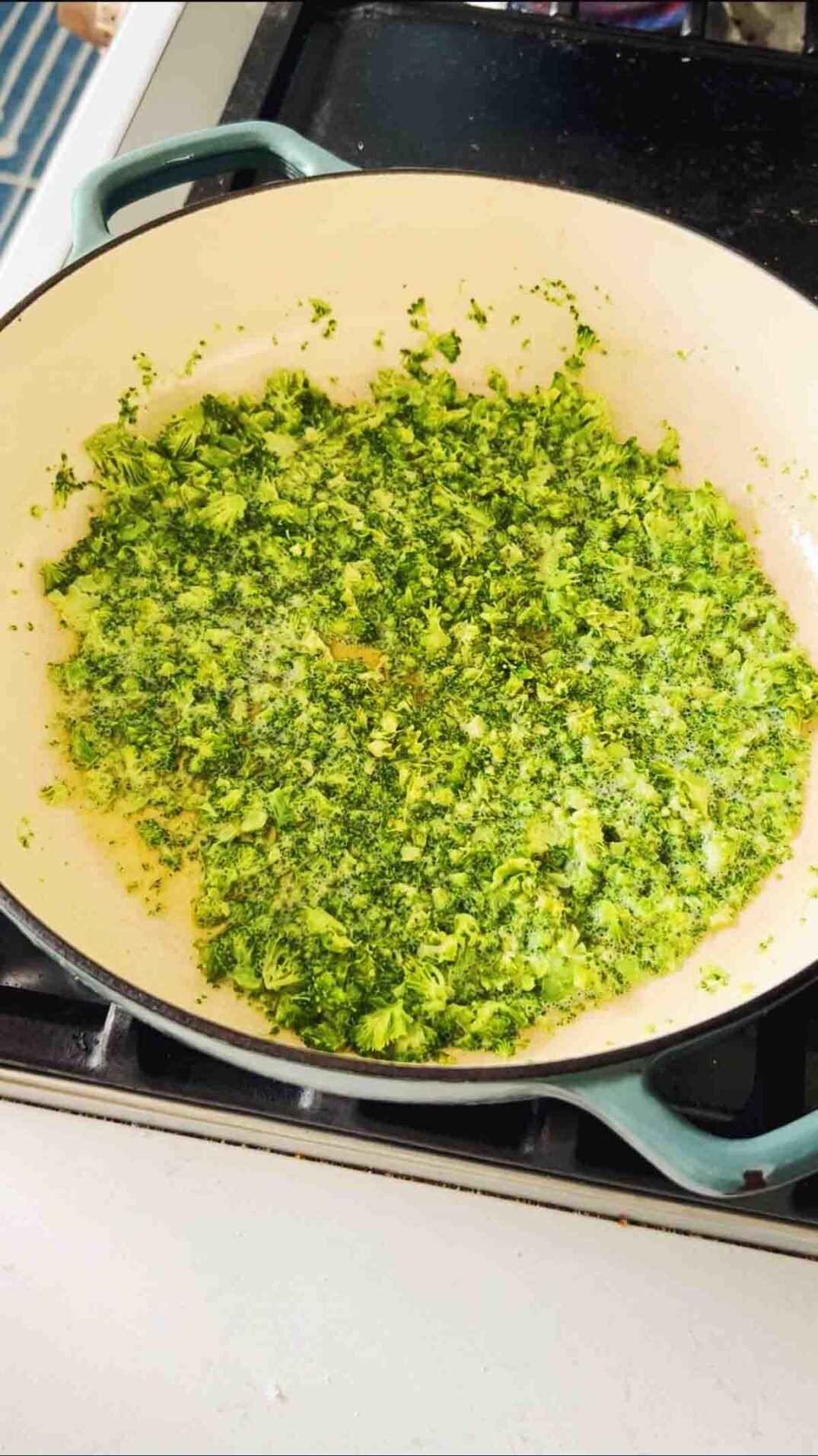 sauteed broccoli bits on the stovetop.