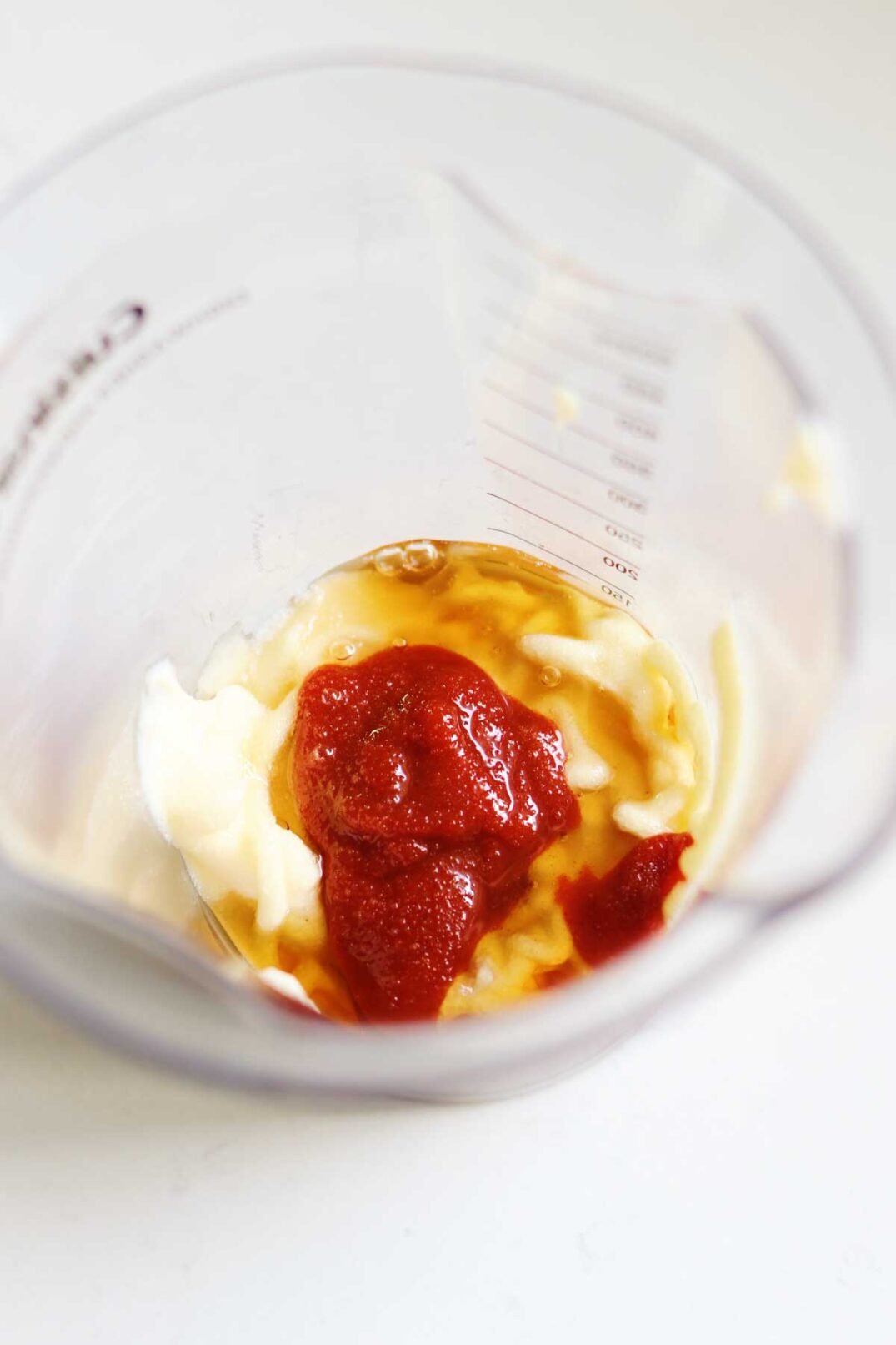 gochujang mayo ingredients in a class measuring cup
