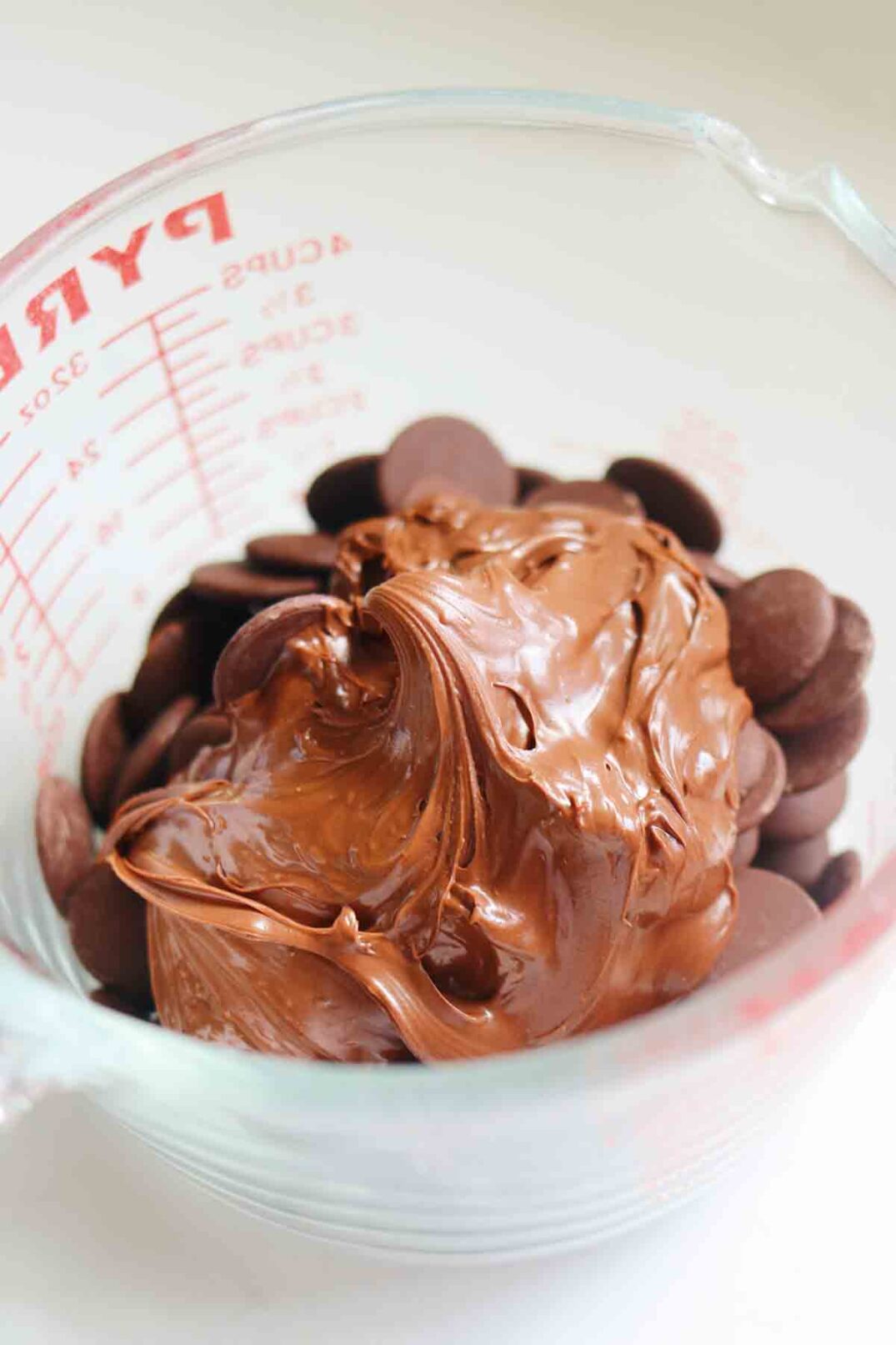 nutella and chocolate chips in a pyrex measuring cup.