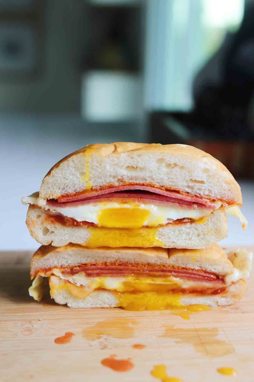 a pork roll egg and cheese sandwich cut in half and stacked on top of each other.