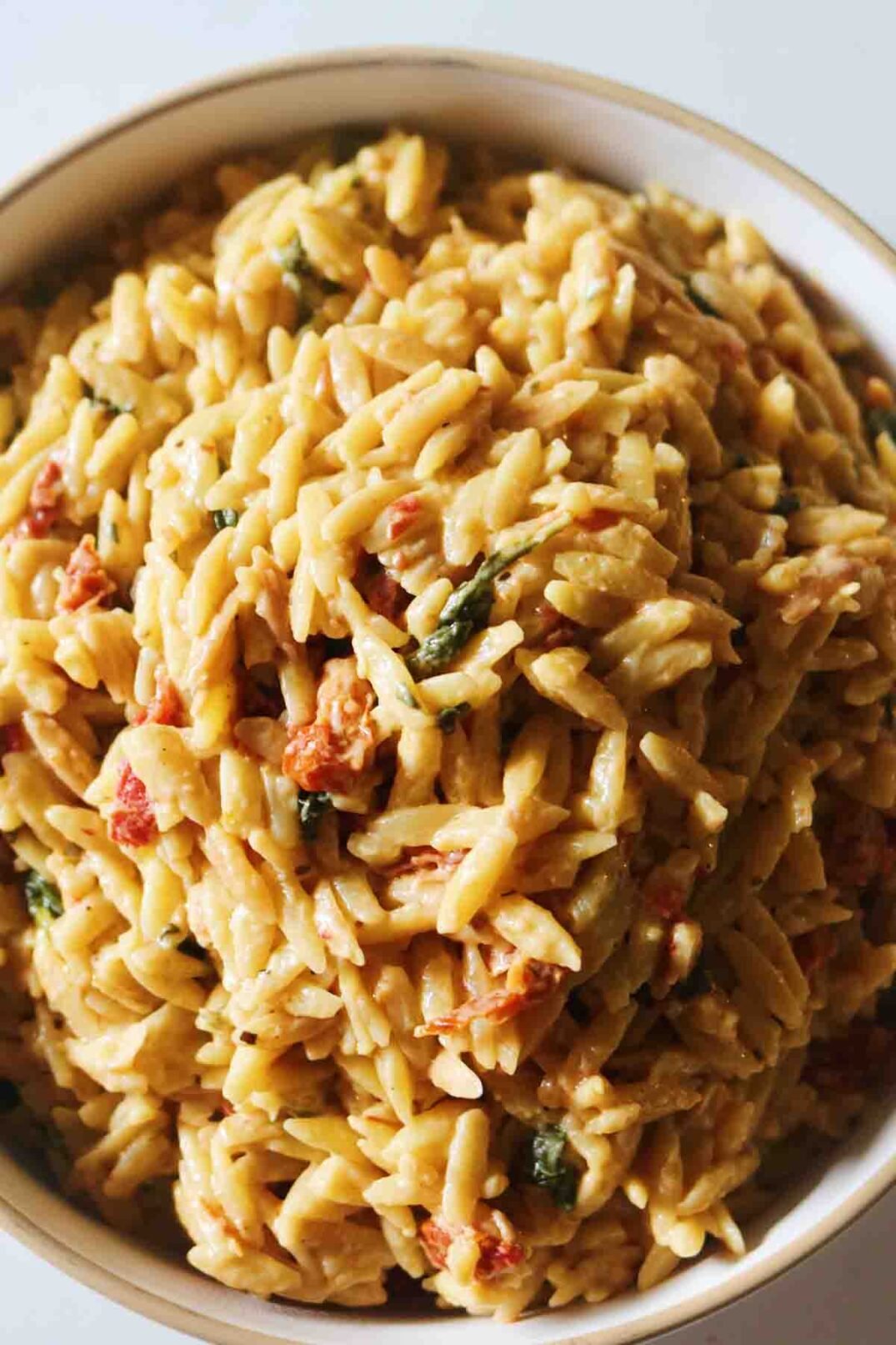 an overhead shot of a bowl of sun dried tomato orzo.