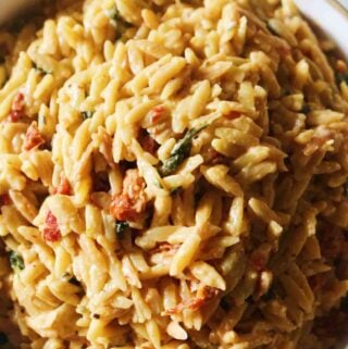 an overhead shot of a bowl of sun dried tomato orzo.