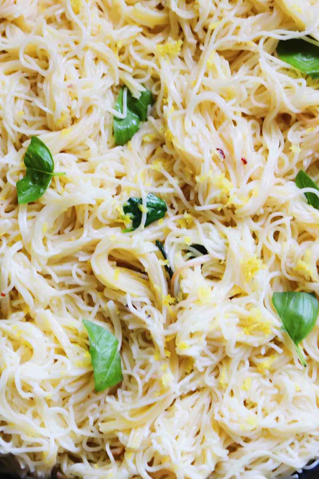 a big plate of tiktok viral one pot lemon pasta with fresh basil throughout