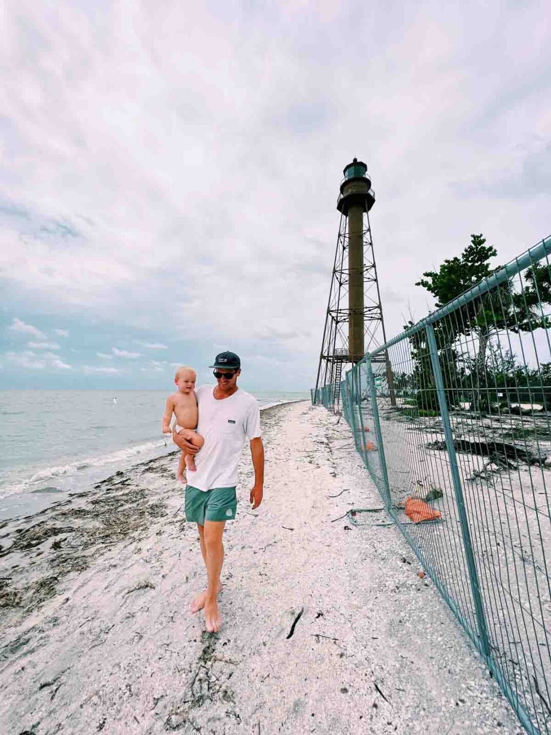 jeremy johnston and jetty johnston walking along the sanibel lighthouse beach after hurricane ian. 