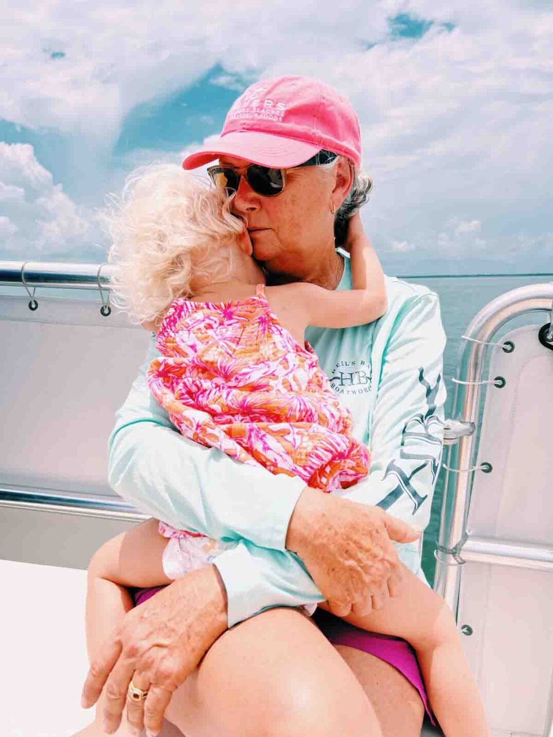 a woman holding a baby on captiva cruises going to cabbage key after hurricane ian. 