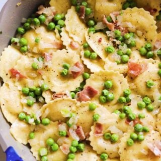 Trader Joe's Cacio e Pepe Ravioli cooked with peas and prosciutto topped with parmigiano and fresh cracked pepper.