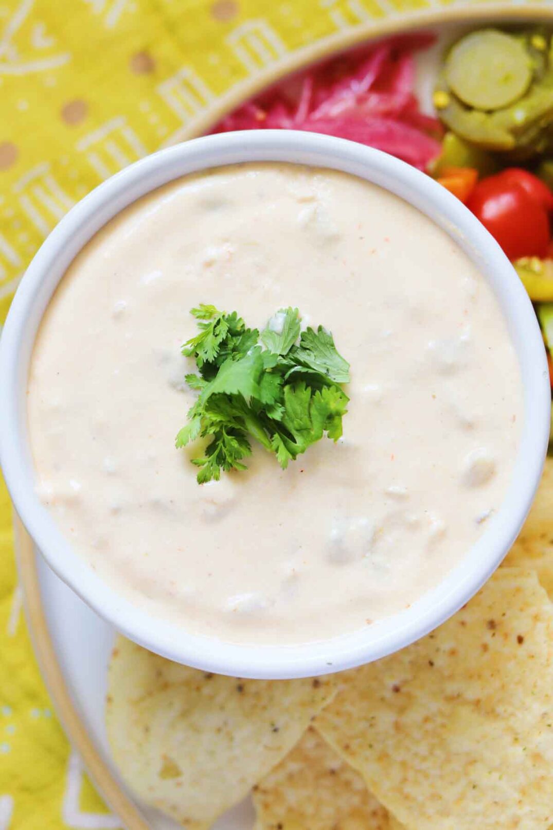 a big white bowl of cottage cheese queso dip.