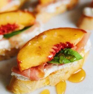 peaches on a ricotta smeared crostini topped with honey honey.