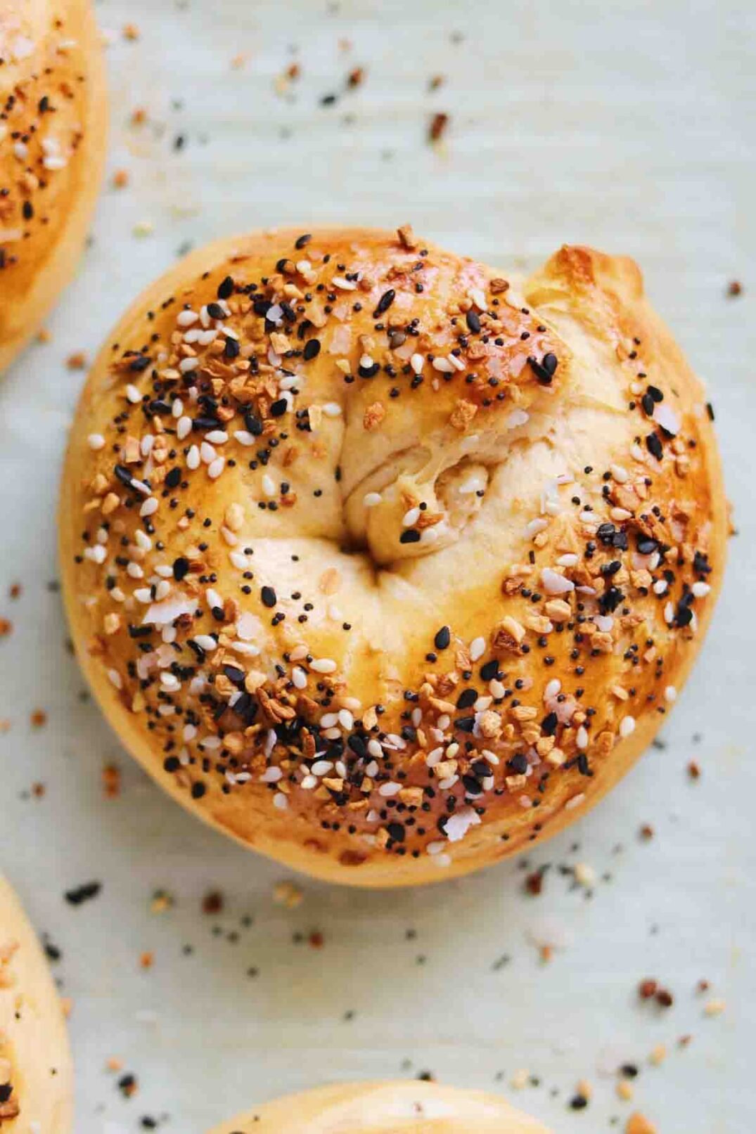 stuffed bagels with everything bagel seed on top of a baking sheet.