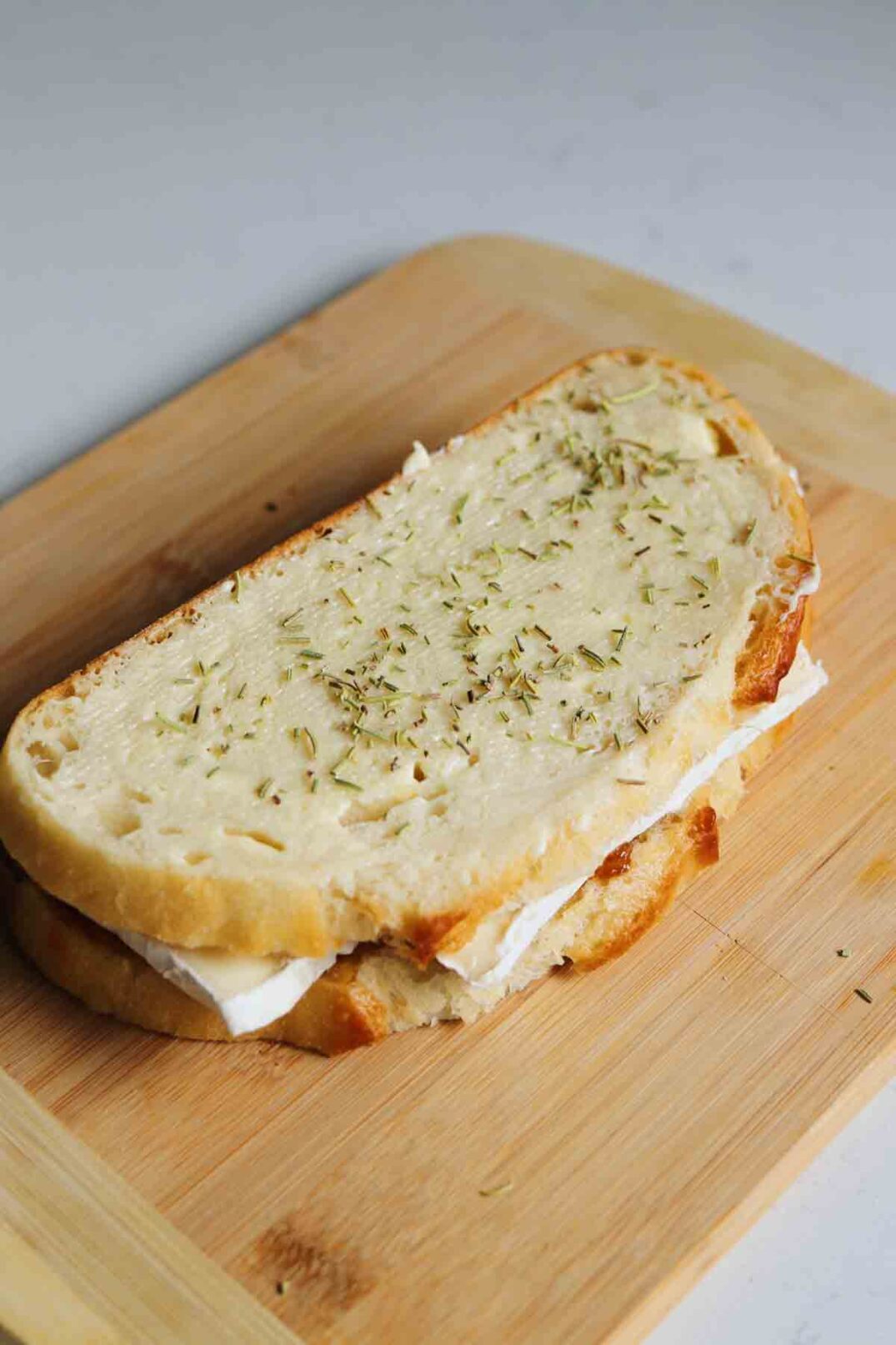 a sandwich sitting on a cutting board.