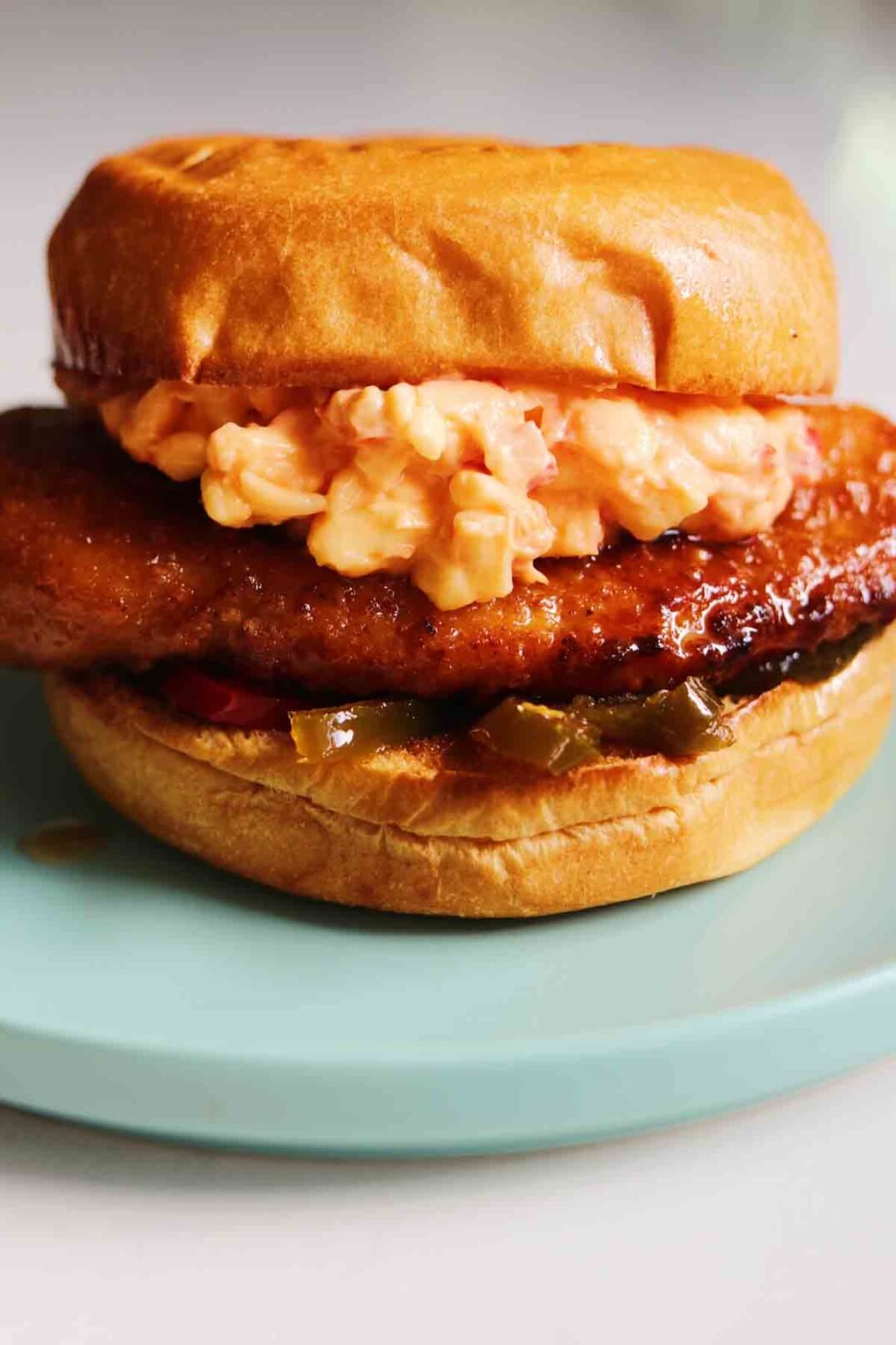a close up of a Chick-fil-a Honey Pepper Pimento Chicken Sandwich Dupe sitting on a white countertop.