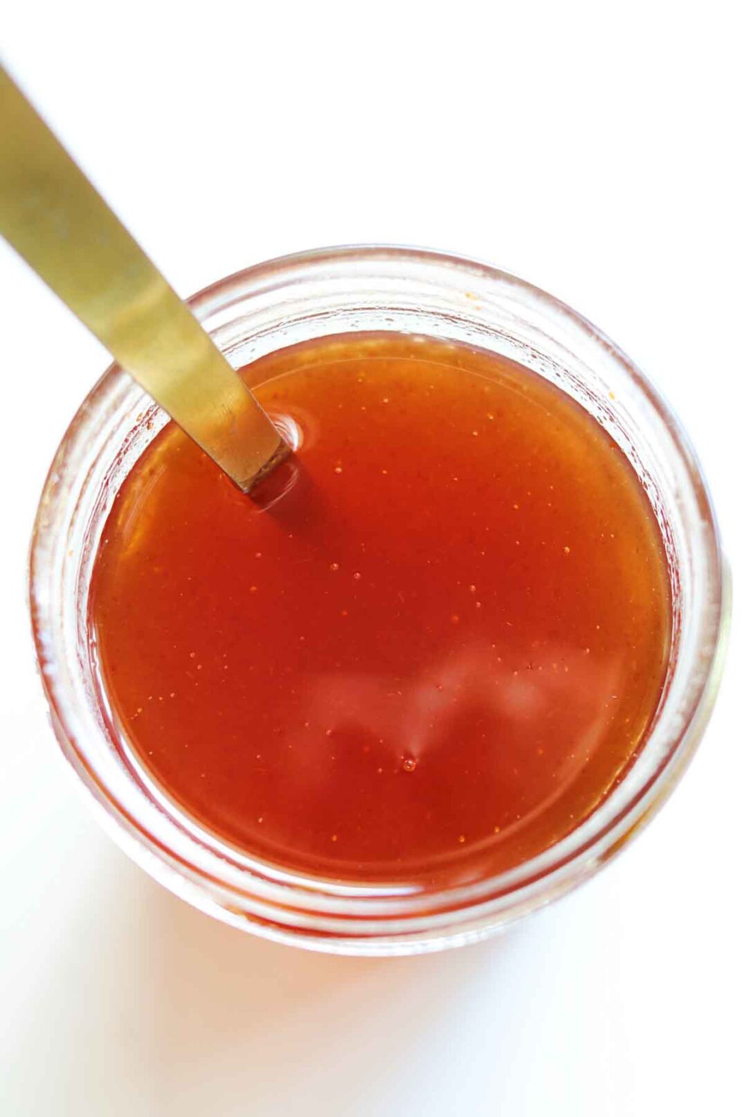 an overhead view of a jar of homemade hot honey sauce