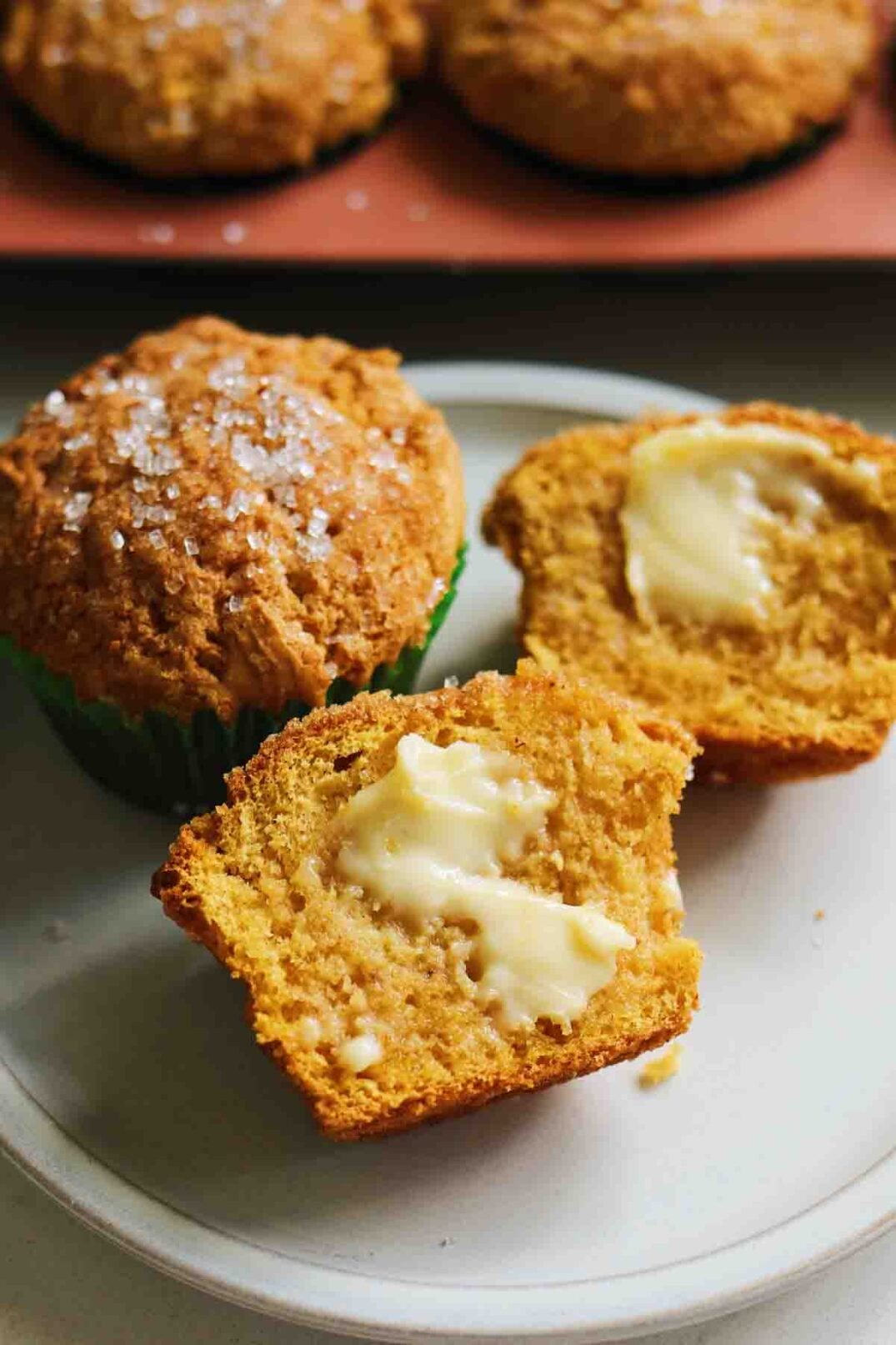 a split open pumpkin muffin with melted butter.