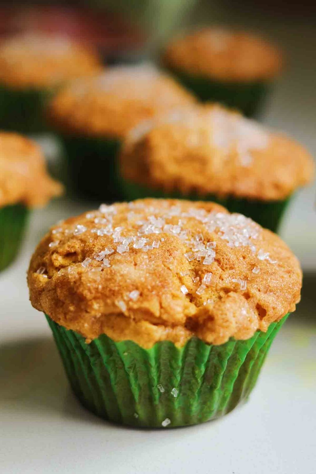 a single pumpkin muffin with a green wrapper. 