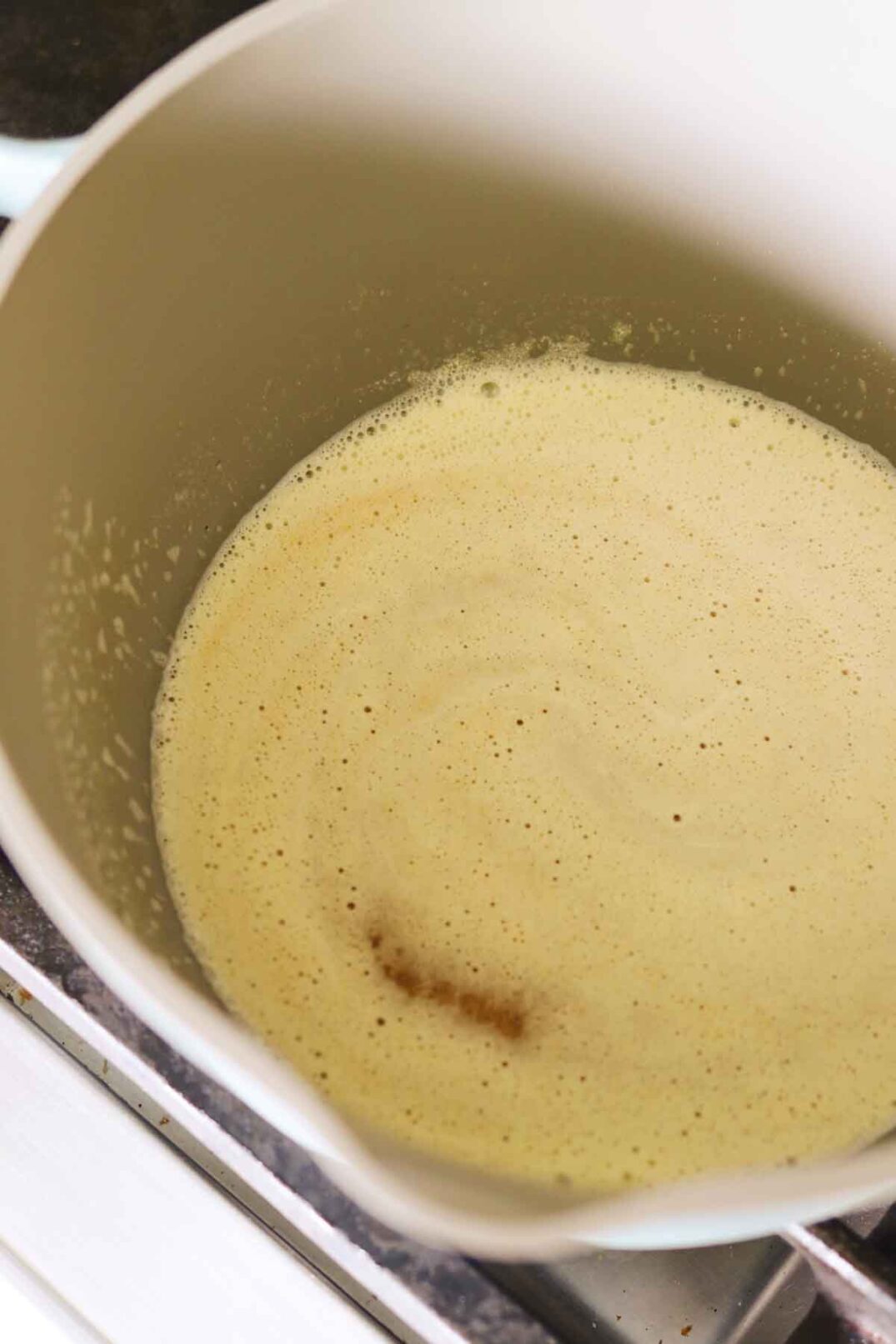 butter foaming and turning brown to make browned butter.